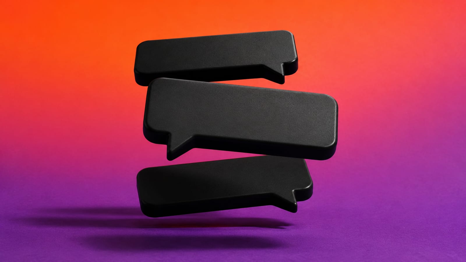 Three matte-black speech-bubble slabs stacked in mid-air against a saturated orange and violet backdrop