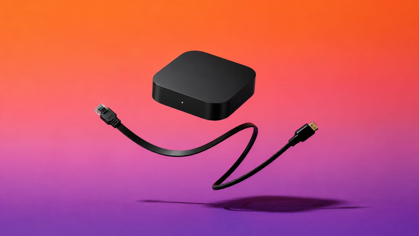 Android TV box floating with its ethernet and HDMI cables against an orange and violet background