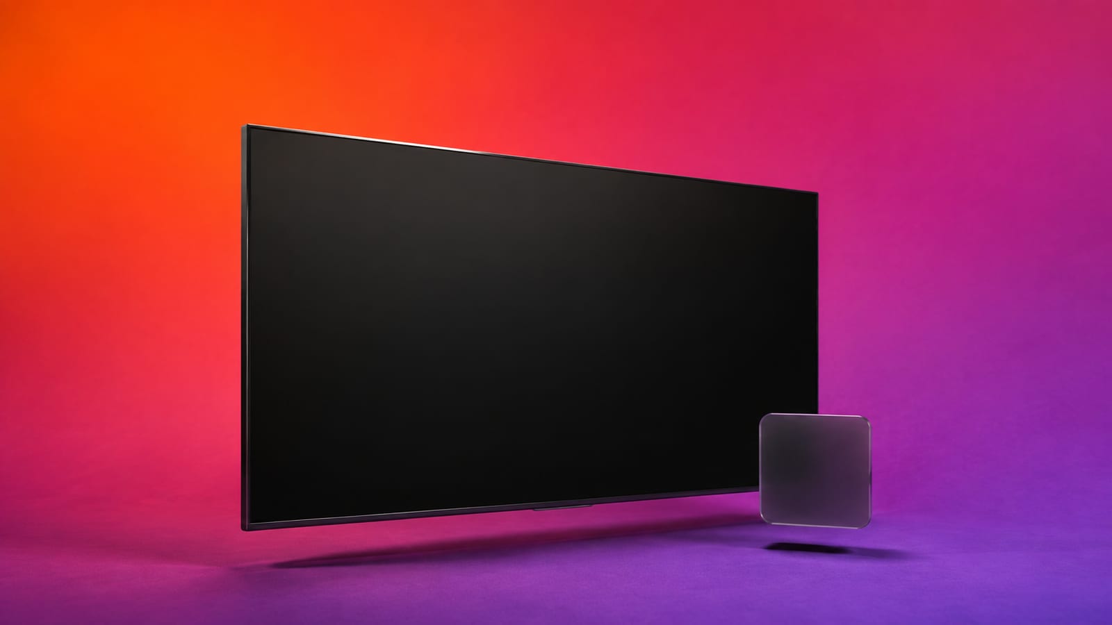 Floating smart television and blank app tile on an orange, magenta and violet studio background