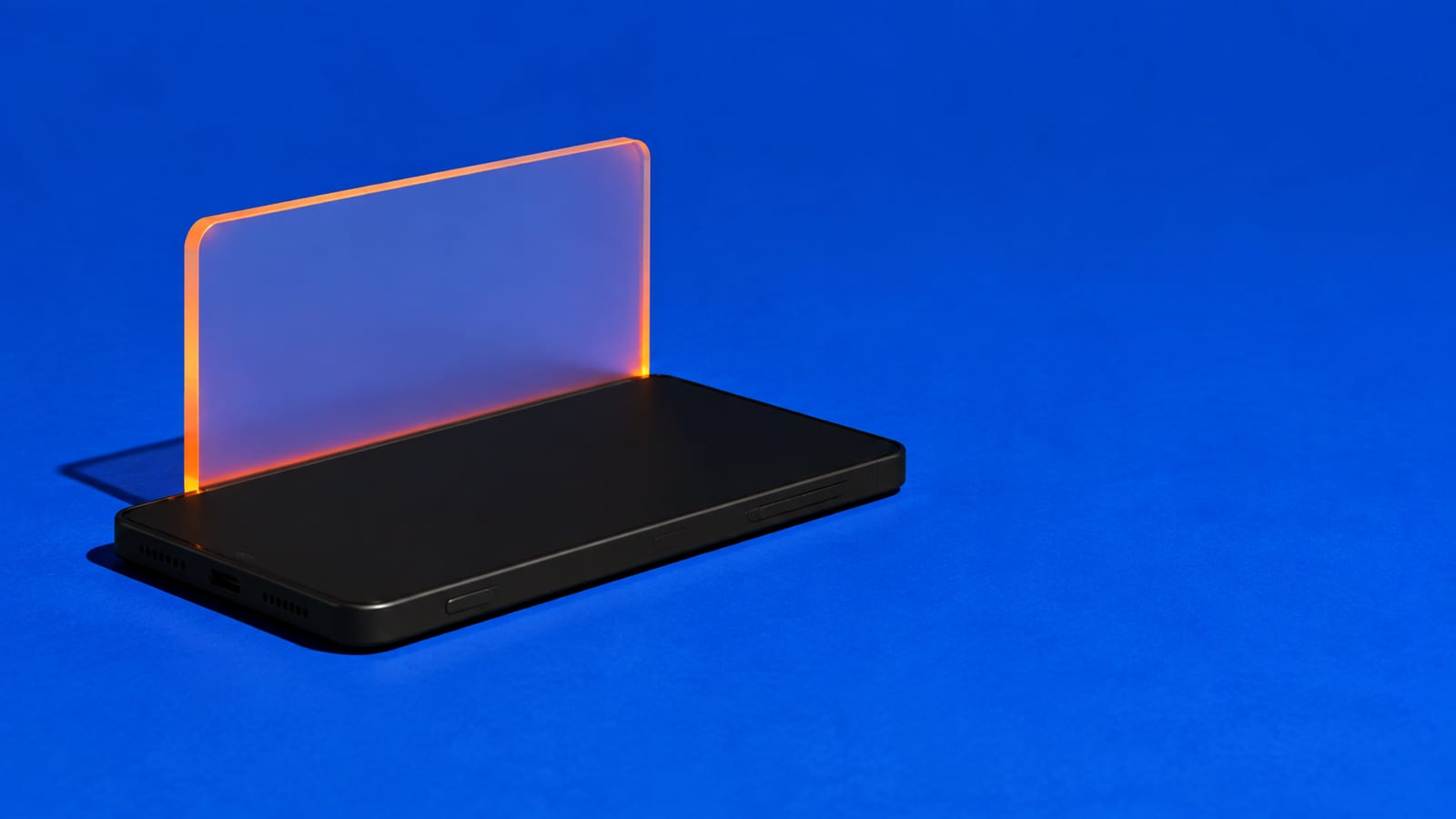 Blank frosted playlist card rising from a black phone on a cobalt blue studio background