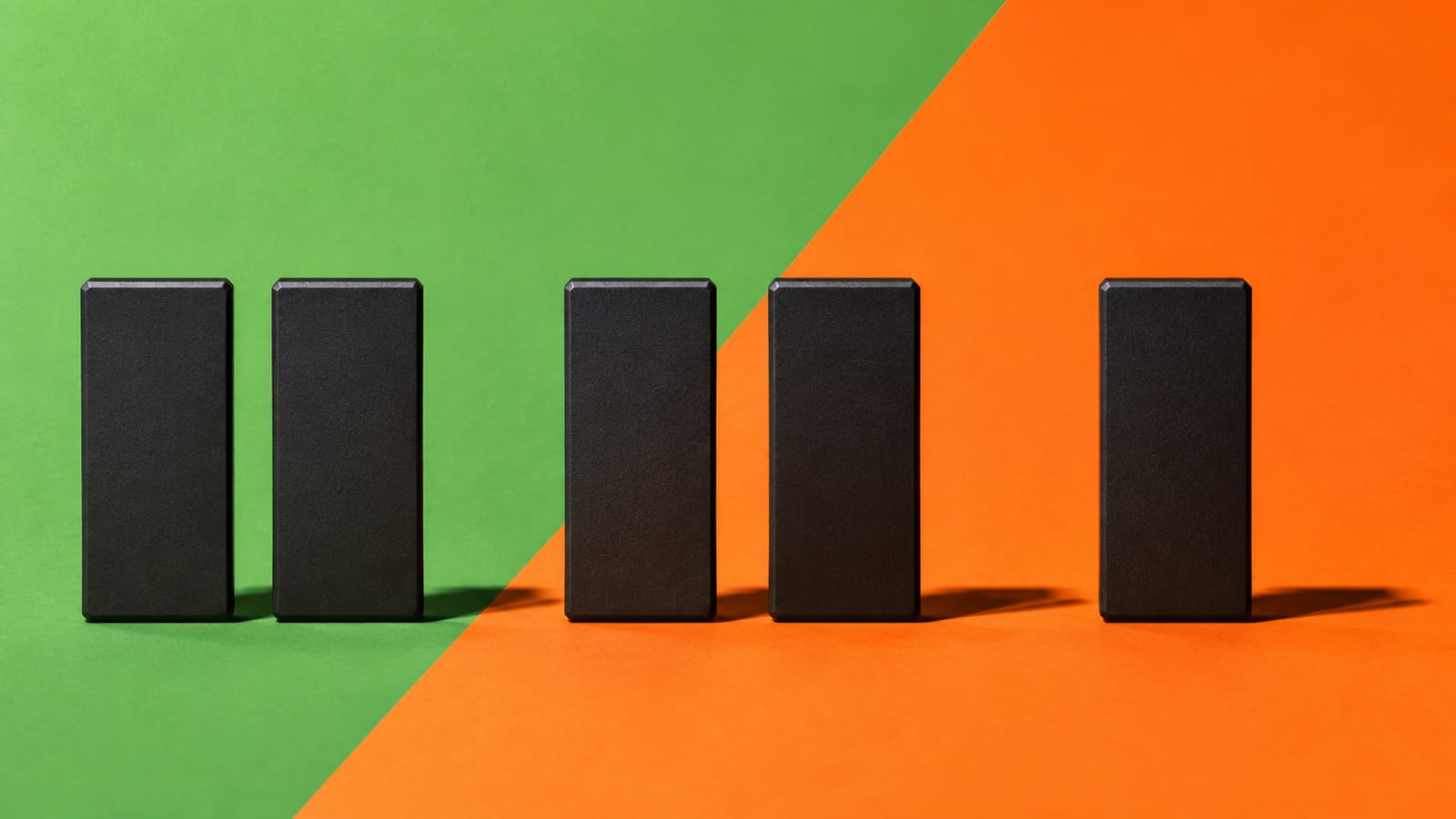 Blank black channel tiles with gaps on a green and orange studio background