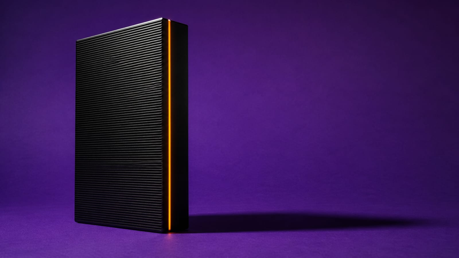 A matte-black server node with one glowing edge casting a hard shadow on a deep violet backdrop